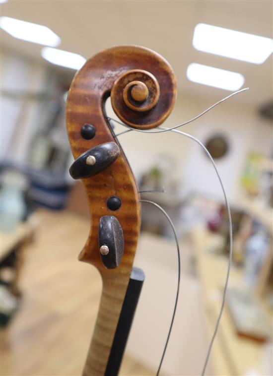 An early 20th century violin, bears label Paolo Fiorini, Taurini 1928, cased with a bow, single-piece back 36cm